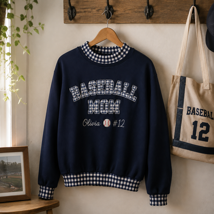 Navy baseball mom gingham sweatshirt hanging on wooden rack